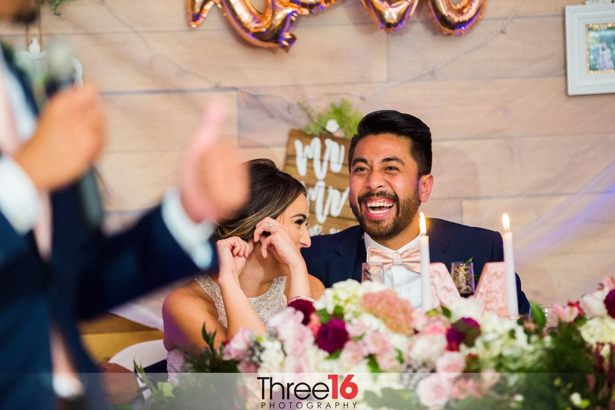 Husband and Wife share a laugh during the toast