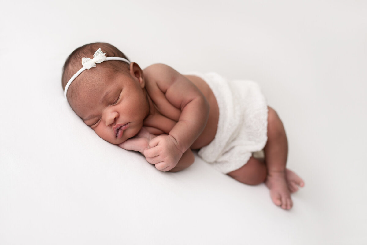 Chin on hand newborn Photoshoot in Houston by Laura King