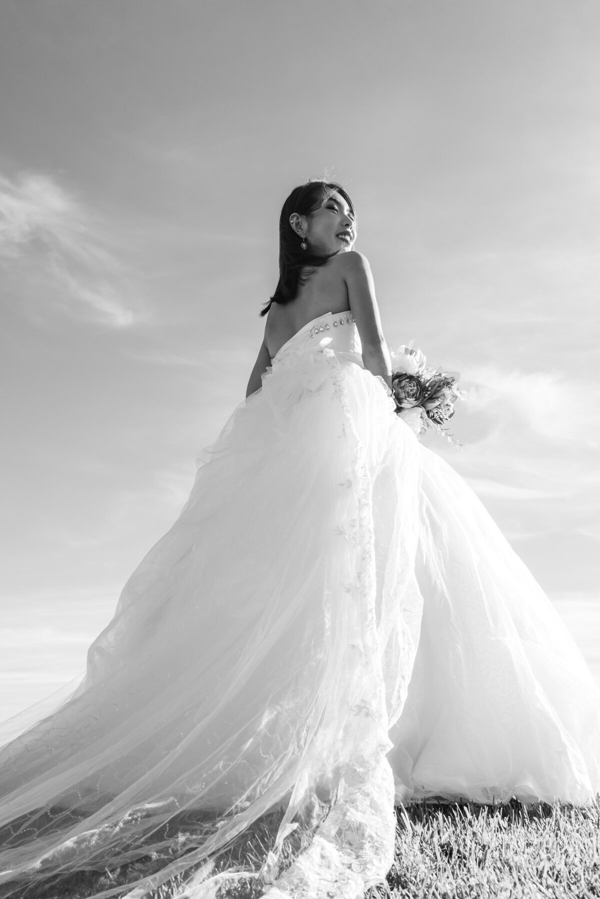 Bride outside with flowing veil