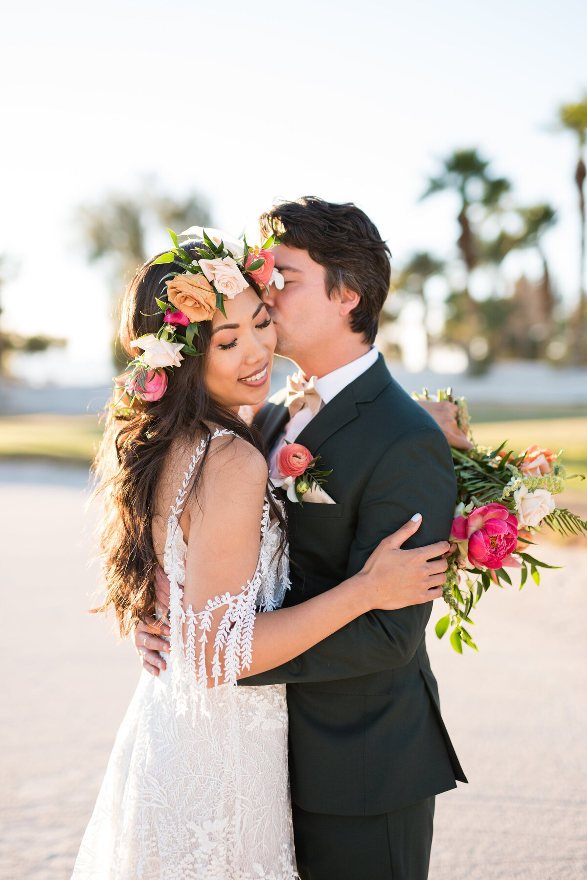 Bride and groom embrace as they go in for a kiss during golden hour at Bali Hai Golf Club in Las Vegas, Nevada.