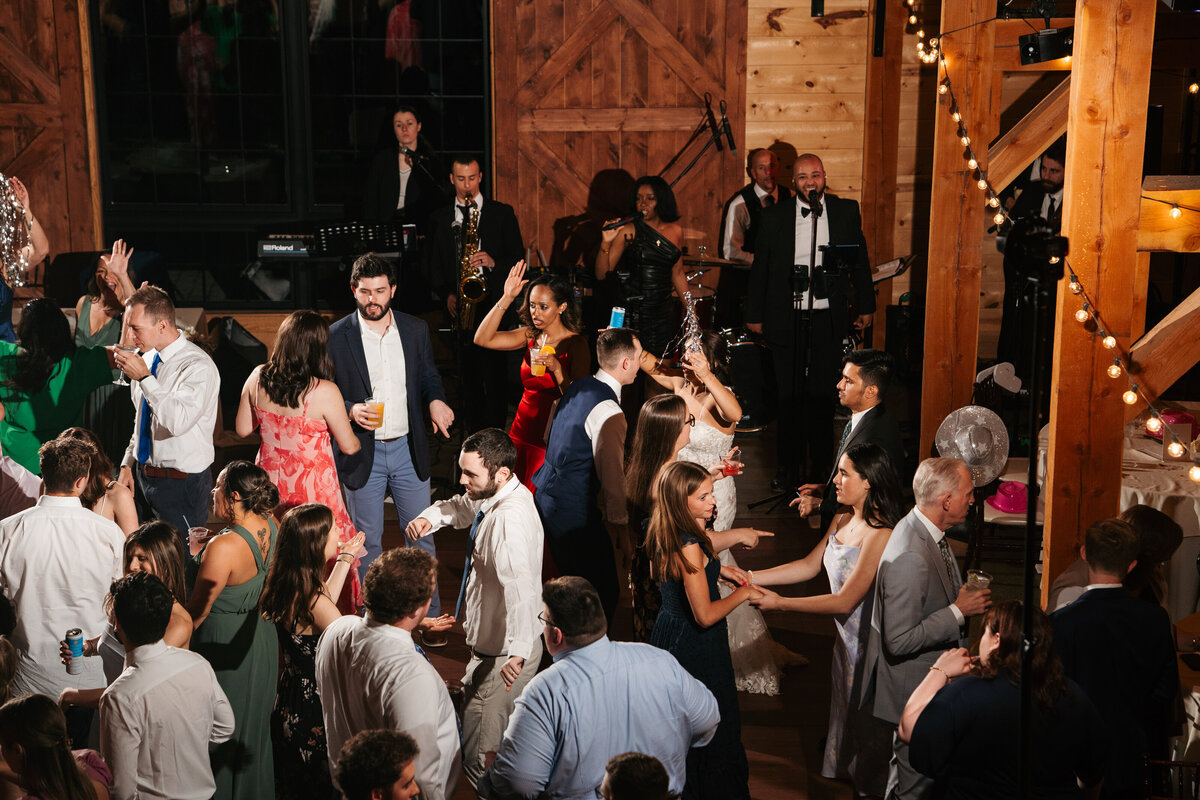 Elegant reception setup with candles, florals, and wooden tables