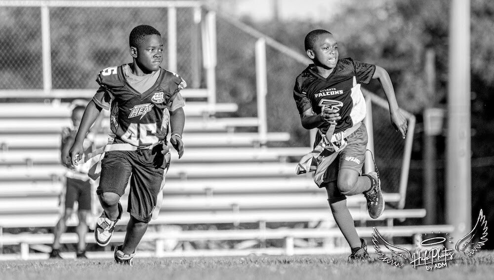 two football players running on the field