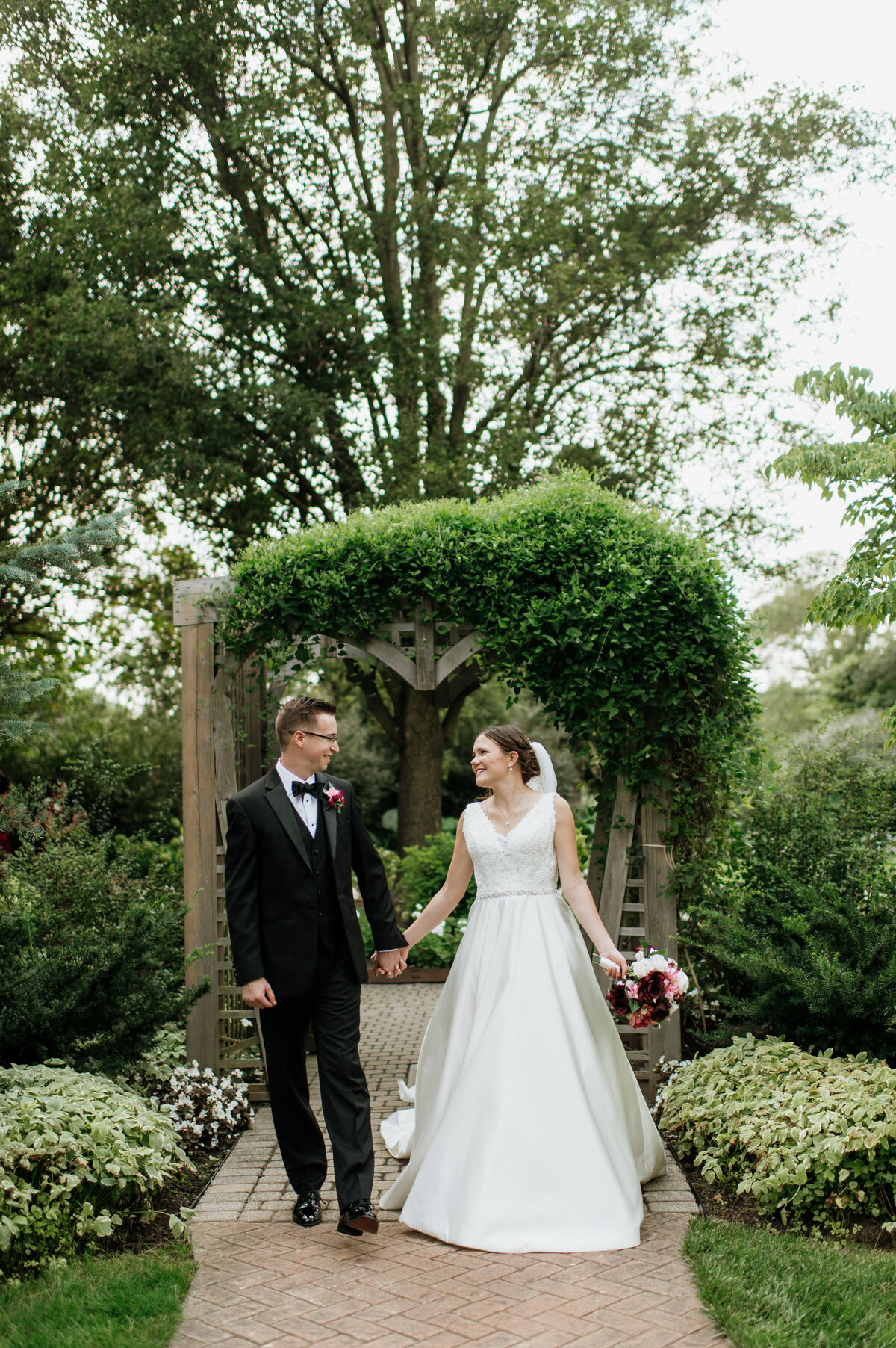 Bride and groom outdoor ceremony under greenery