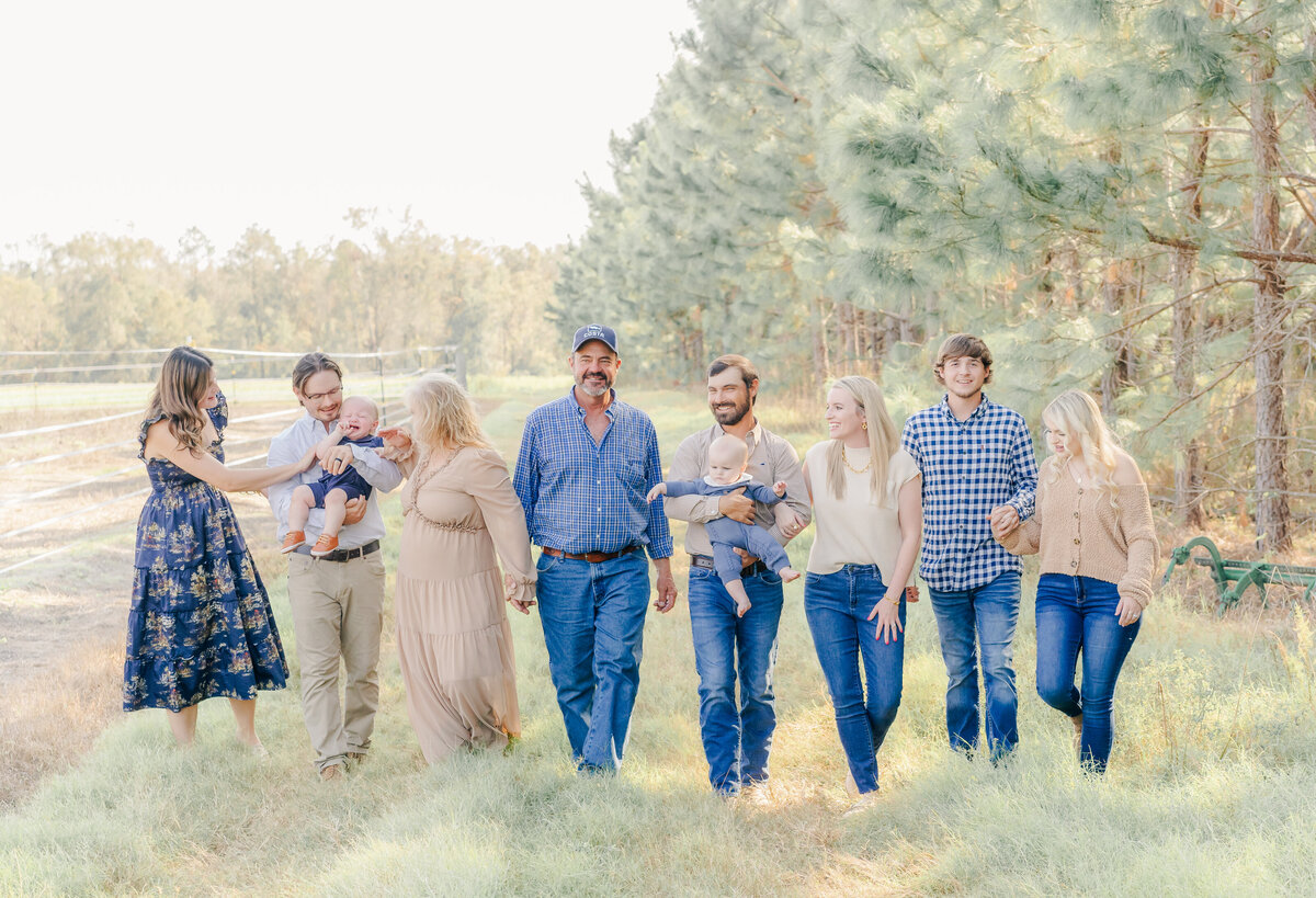 entire happy family walking in line laughing and enjoying each other at their fall photo shoot