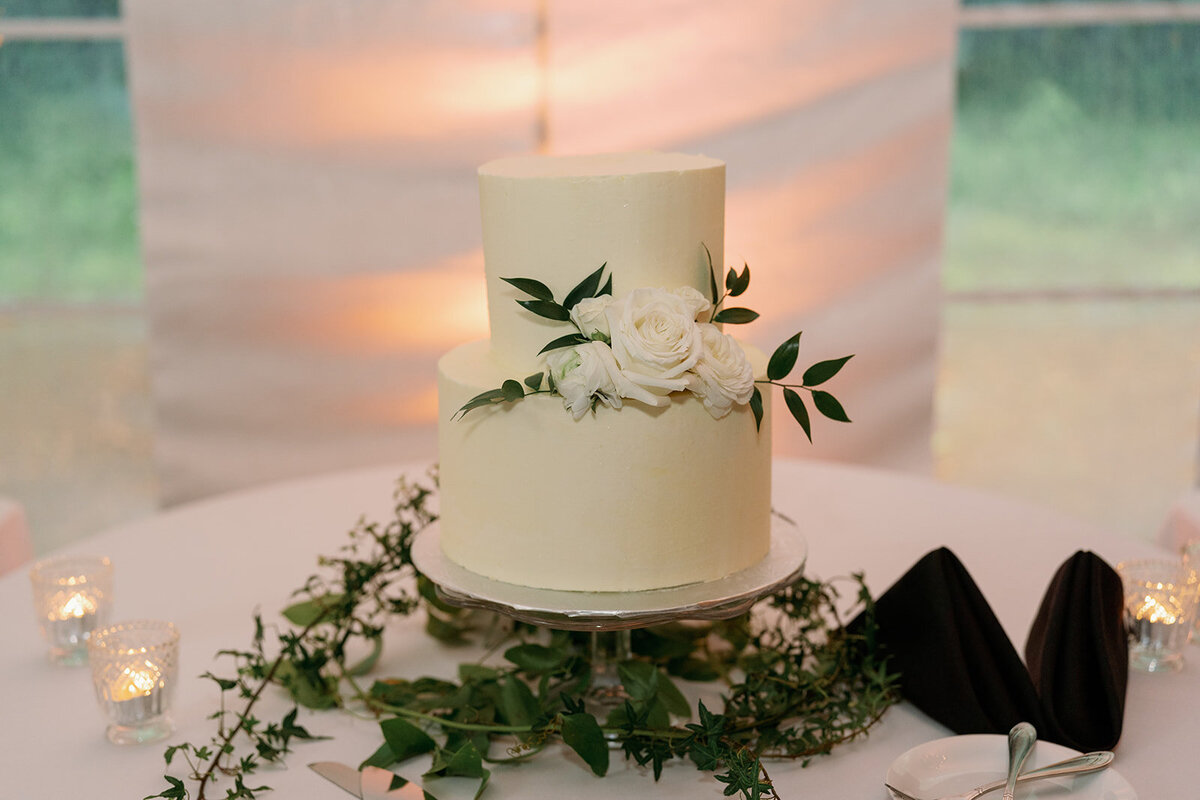 Single-tier white wedding cake with greenery at The Morris Estate reception.