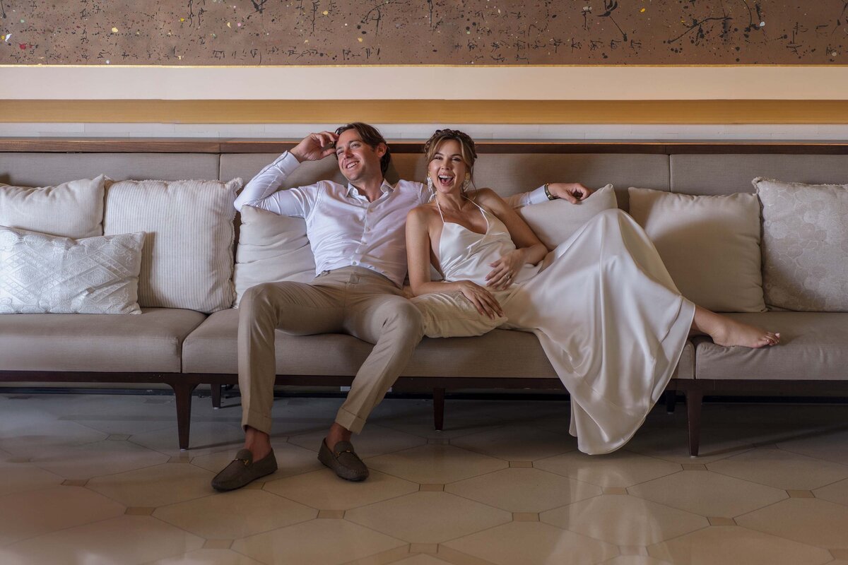 laughing couple on a couch