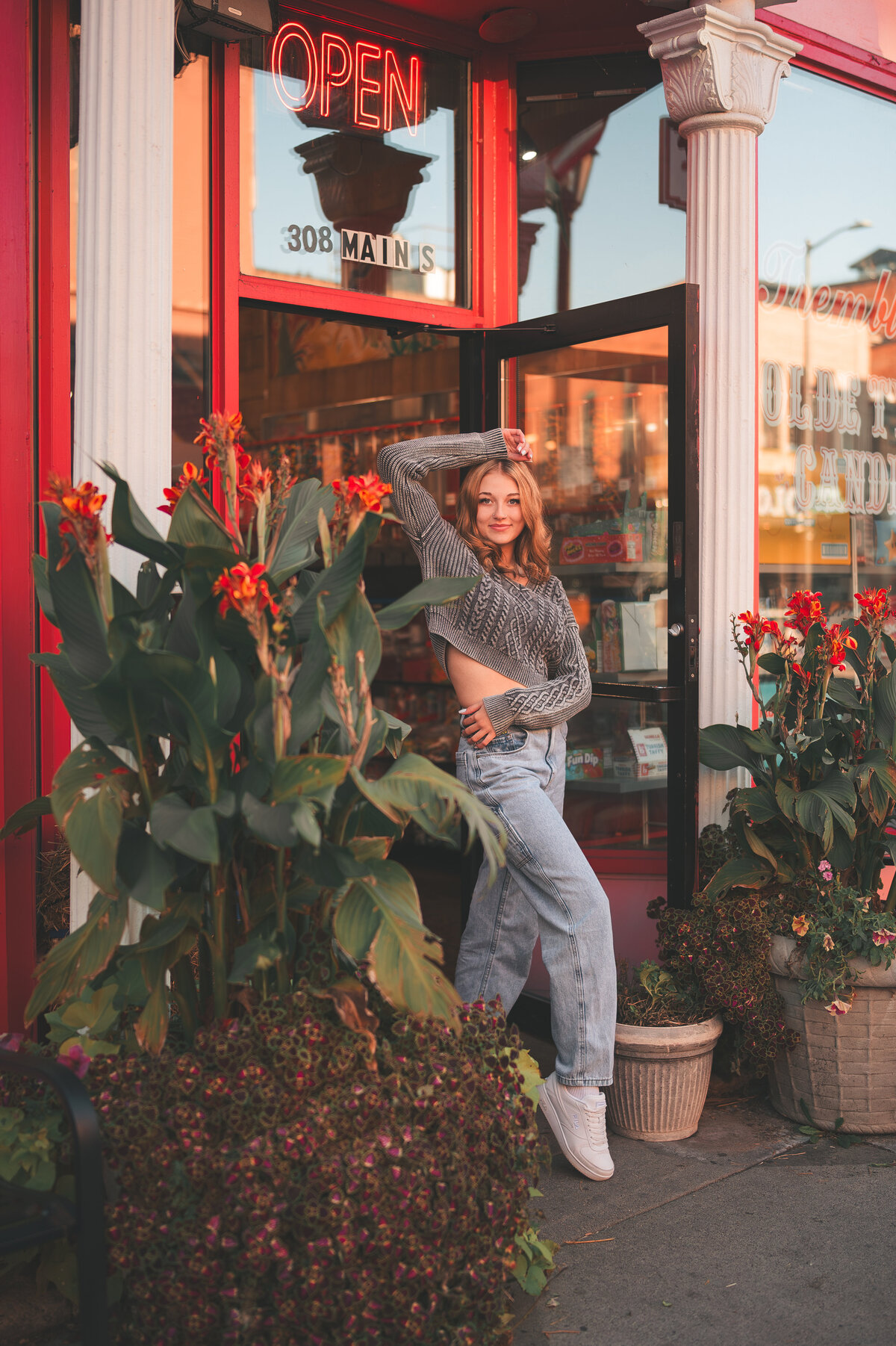 girl posing outside of a shop surrounded by plants in downtown Stillwater, MN