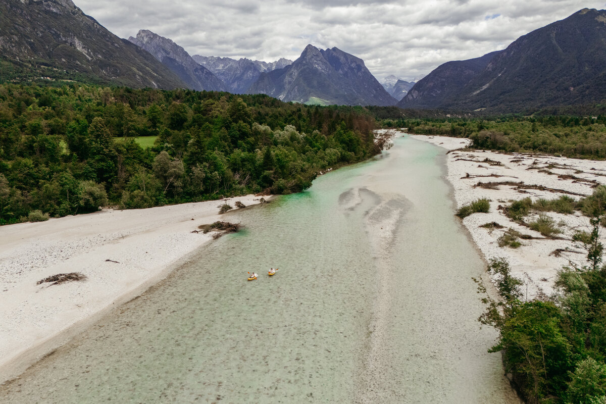 Aerial view of brides in yellow packraft in Soča Valley river elopement