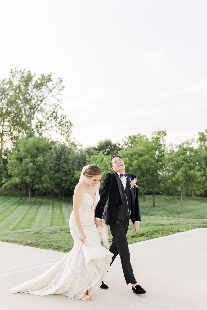 bride and groom walking while laughing