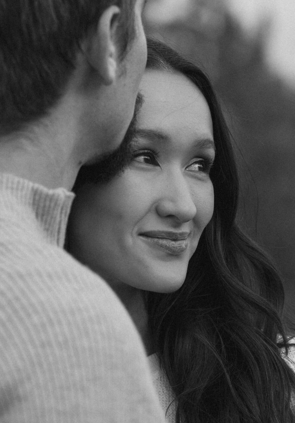 engagement couple sharing an intimate moment while the soon to be groom kisses girlfriend on the forehead