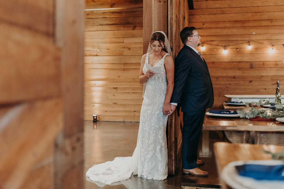 A bride and groom doing a first look and reading each other notes