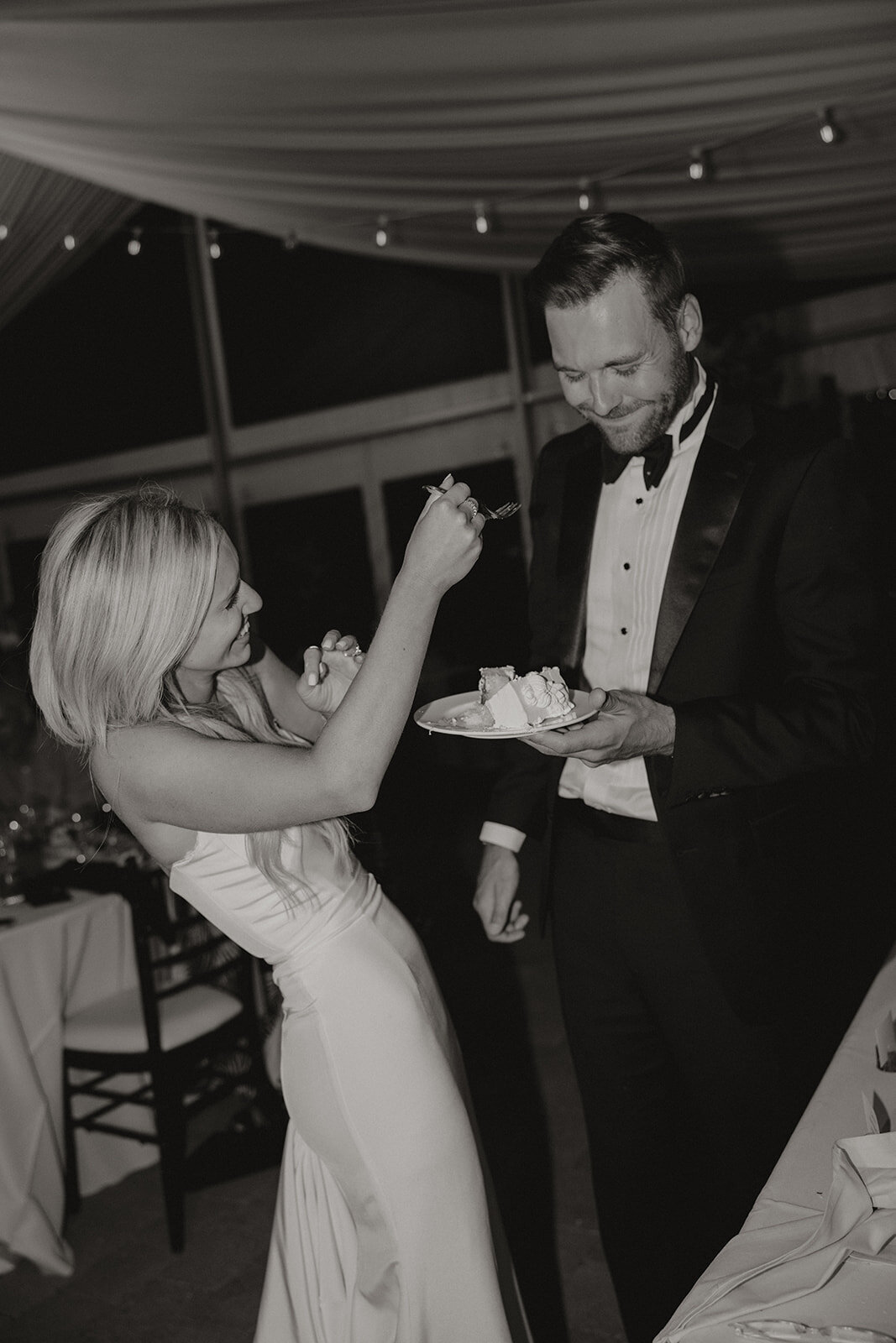 Newlyweds enjoying their wedding cake