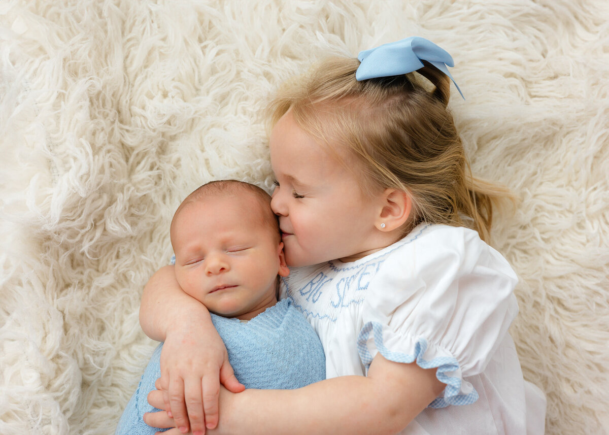 Big sister loving on her new baby brother in a studio in Savannah, Ga