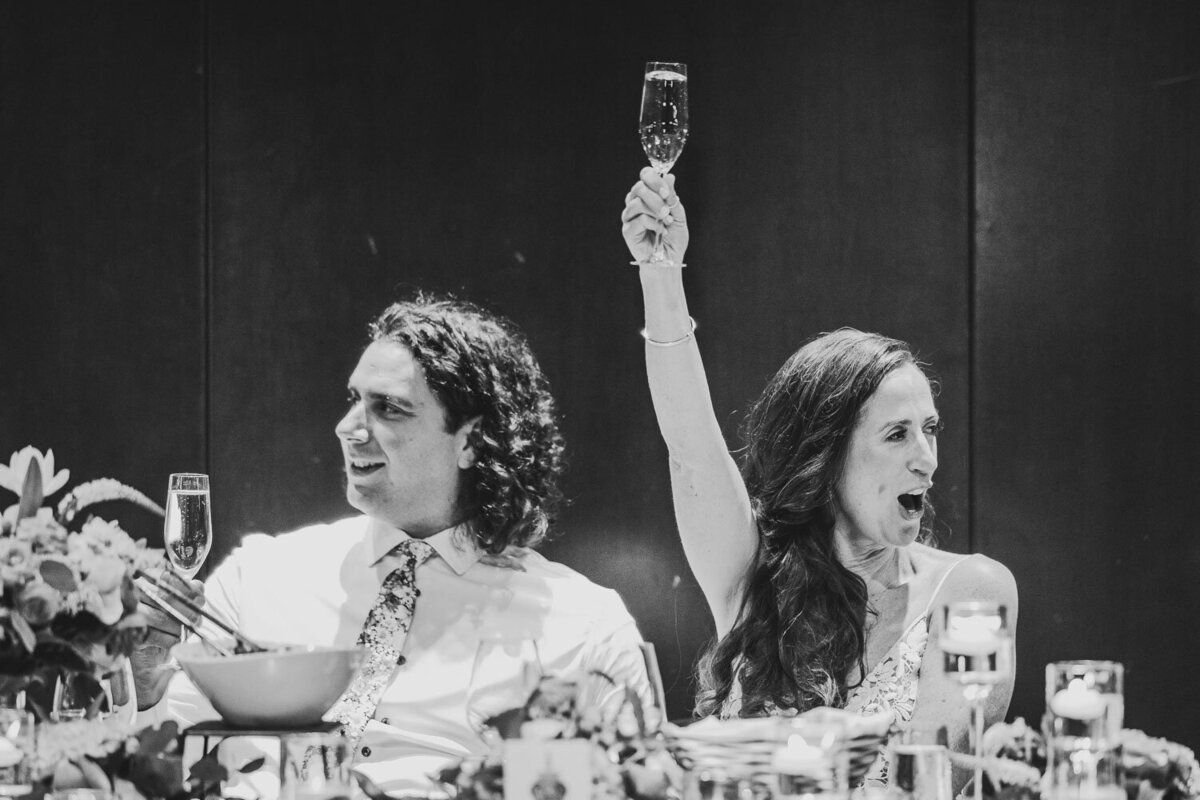 Bride and groom photo with brides holding a glass of champagne