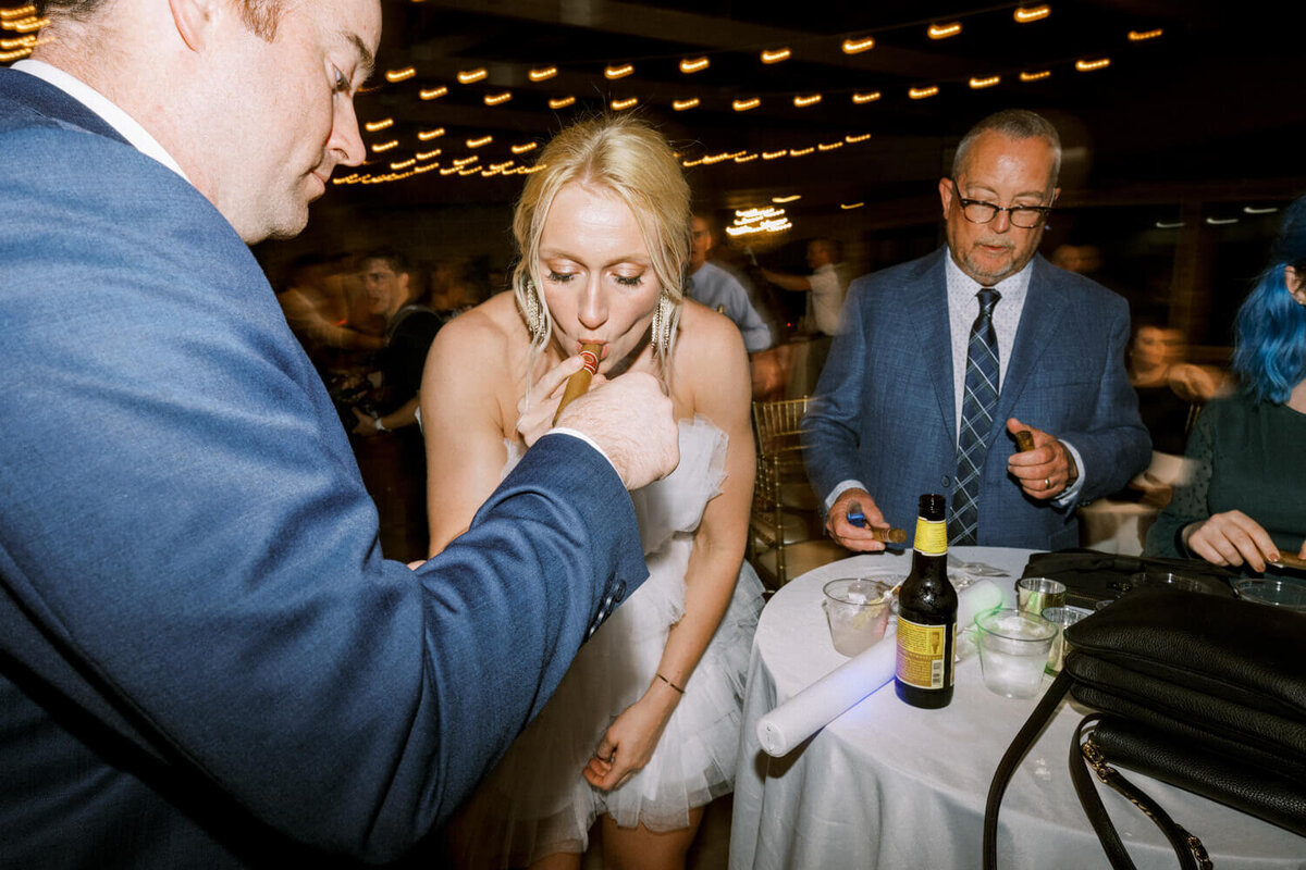 bride-smoking-cigar-while-it-is-being-lit