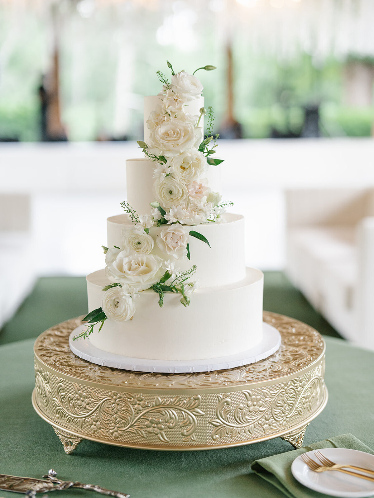 white wedding cake with with and green flowers