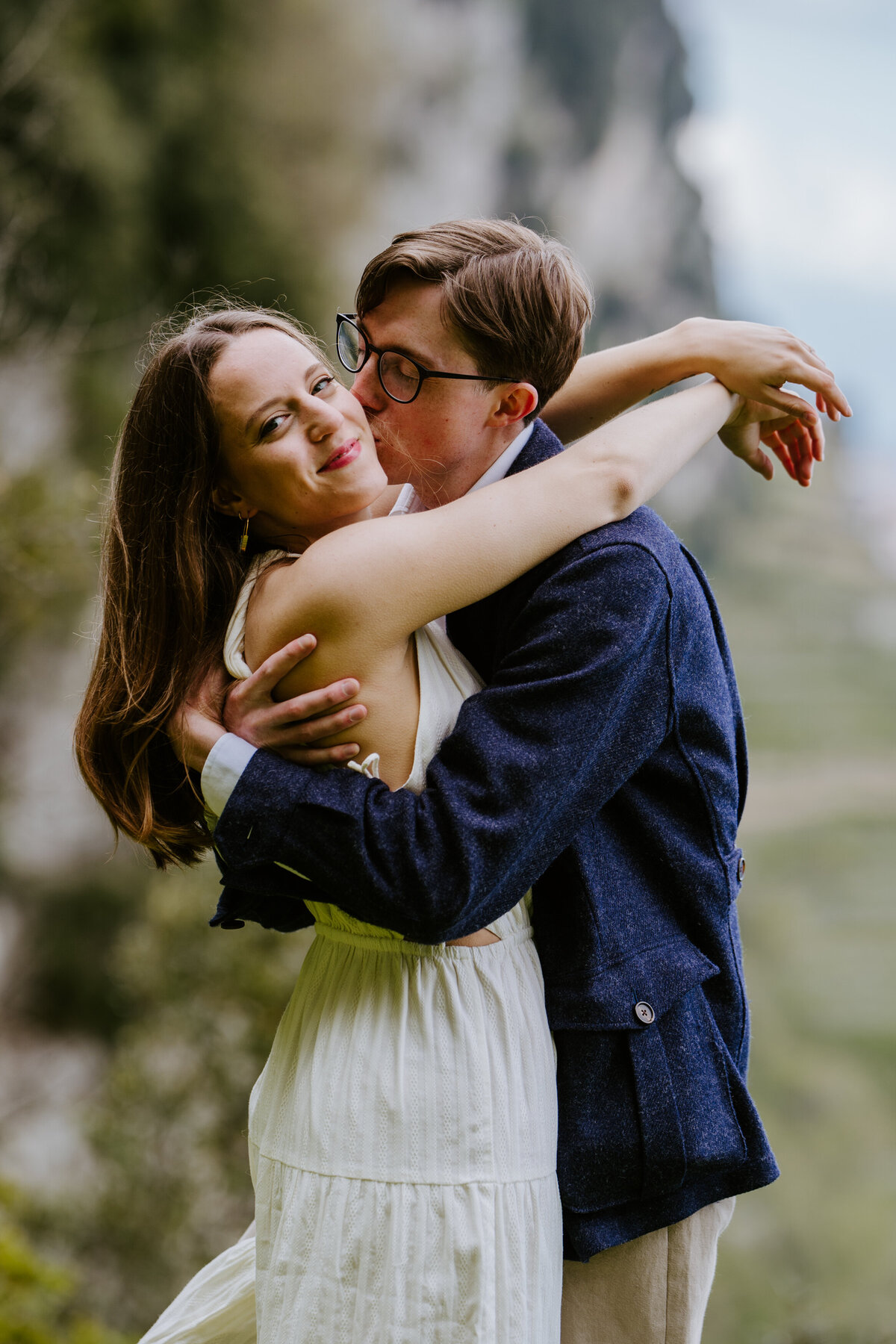 Couple hugging on a cliffside trail