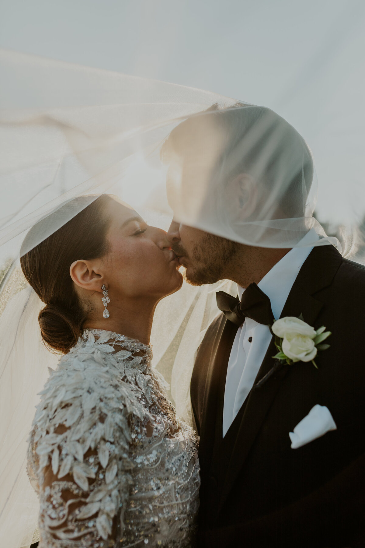 Bride and groom share a romantic kiss at sunset, Indiana wedding photography.