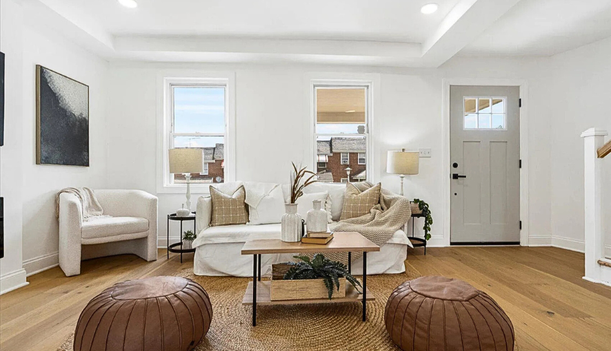 Bright and welcoming living room remodel with wide-plank hardwood floors, custom trim work, and modern finishes—designed to create an inviting space for everyday living and entertaining.