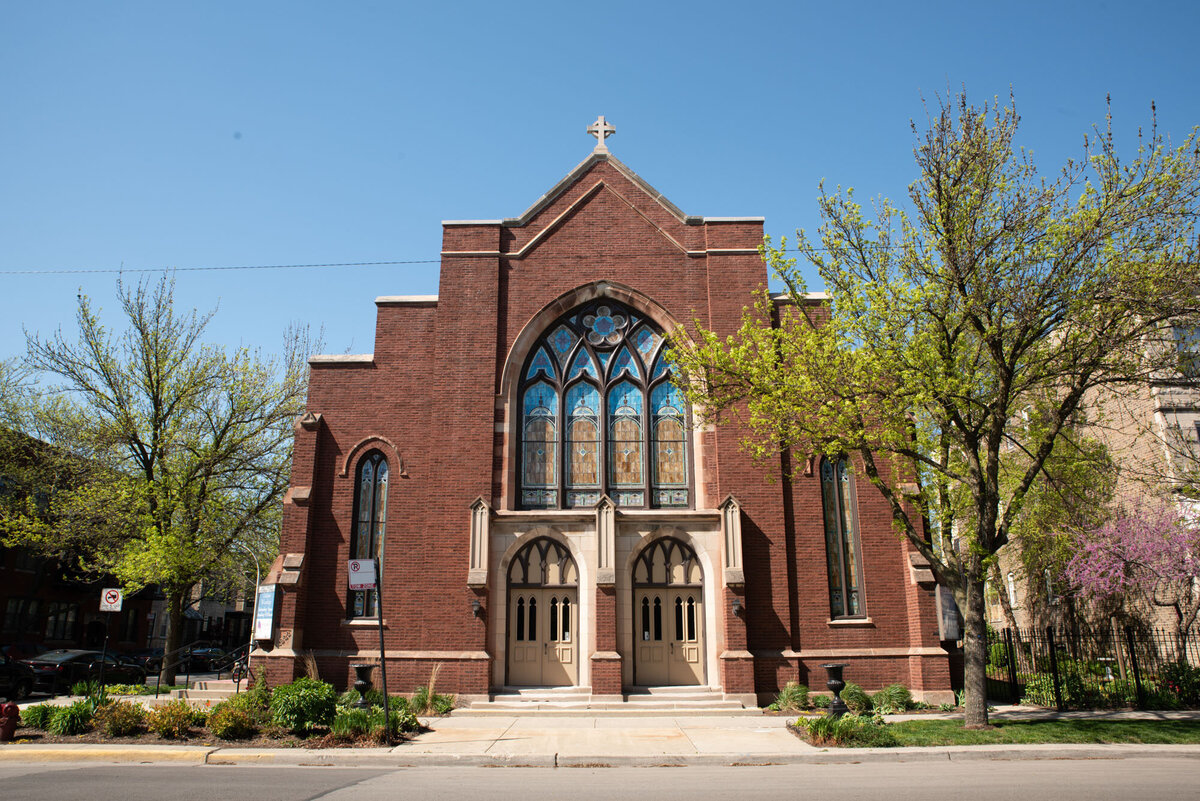 A brick church with a cross on top of it