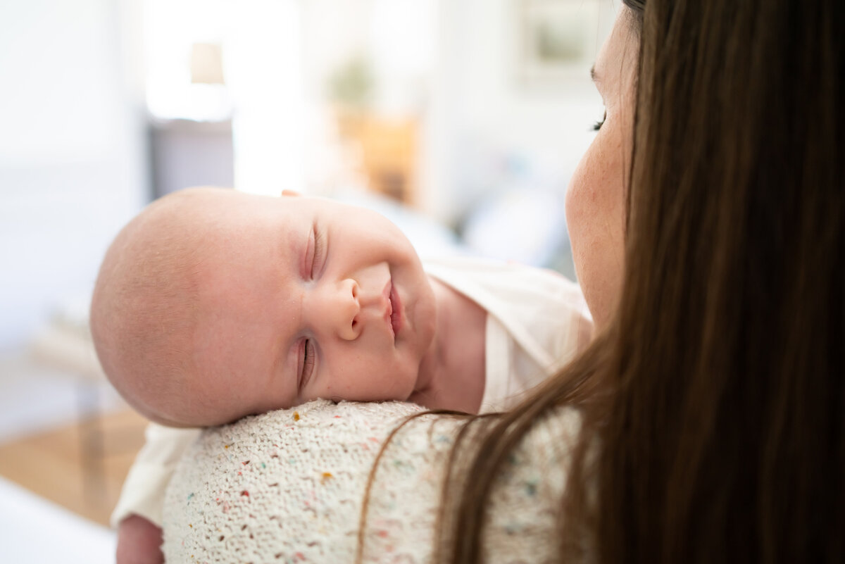 Newborn passed out on mom's shoulder