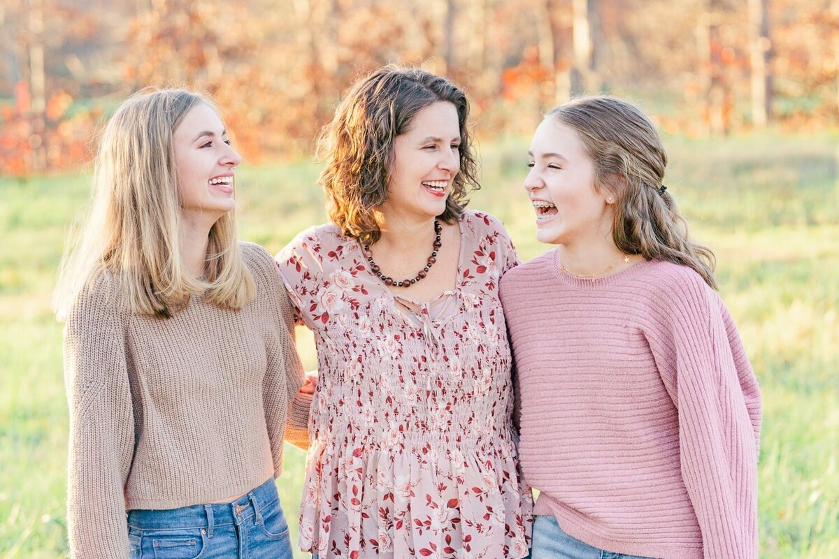 mom & teenage kids laughing taken by a family photographer in Gainesville, Virginia