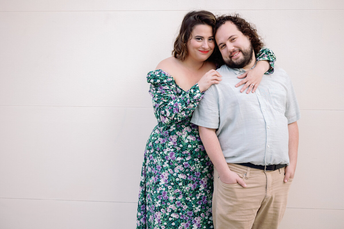 A couple with their arms around each other smiling