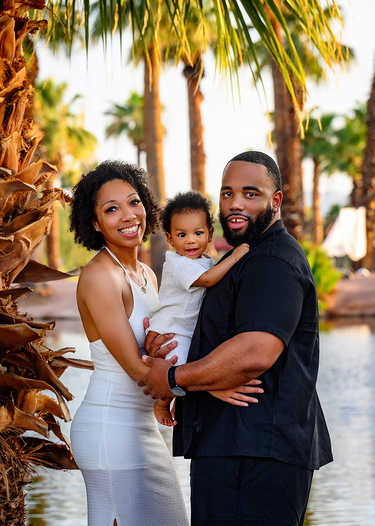 family photo of mom, dad and 9month old surrounded by palm trees in Papago Park