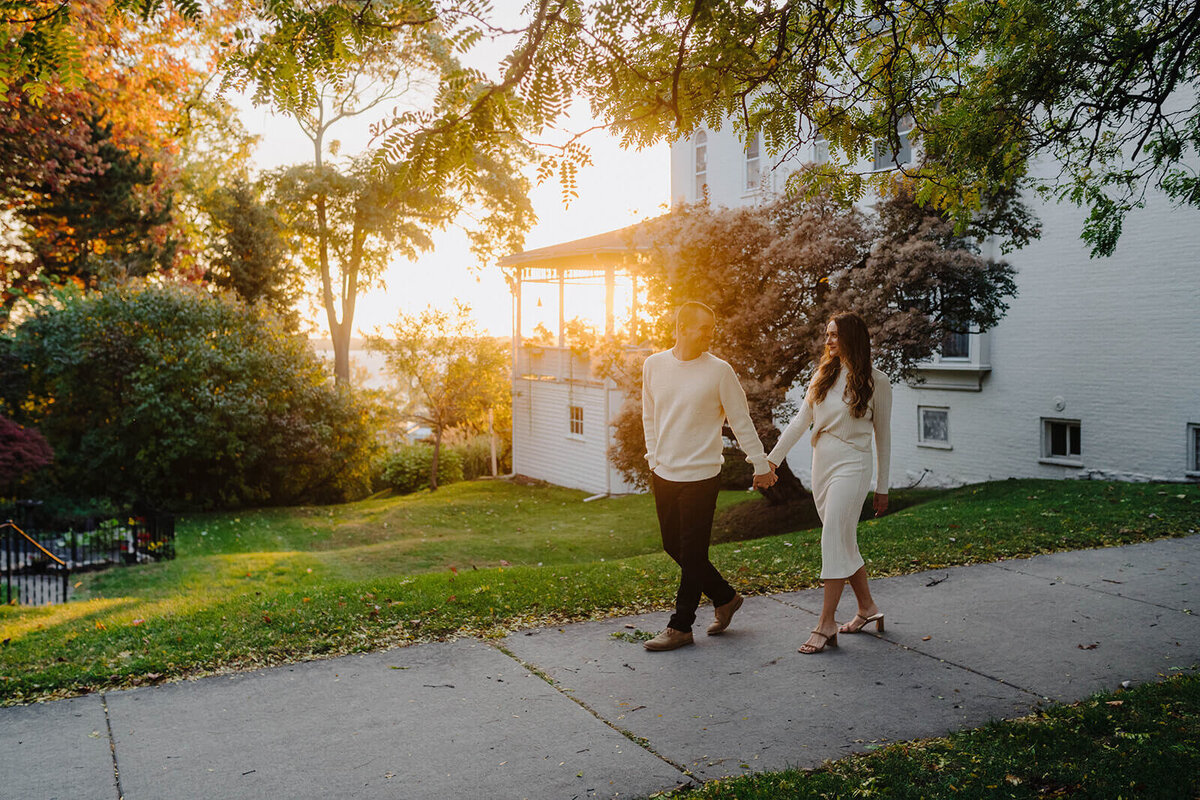 Couple walking along in a neighborhood in Finger Lakes, NY