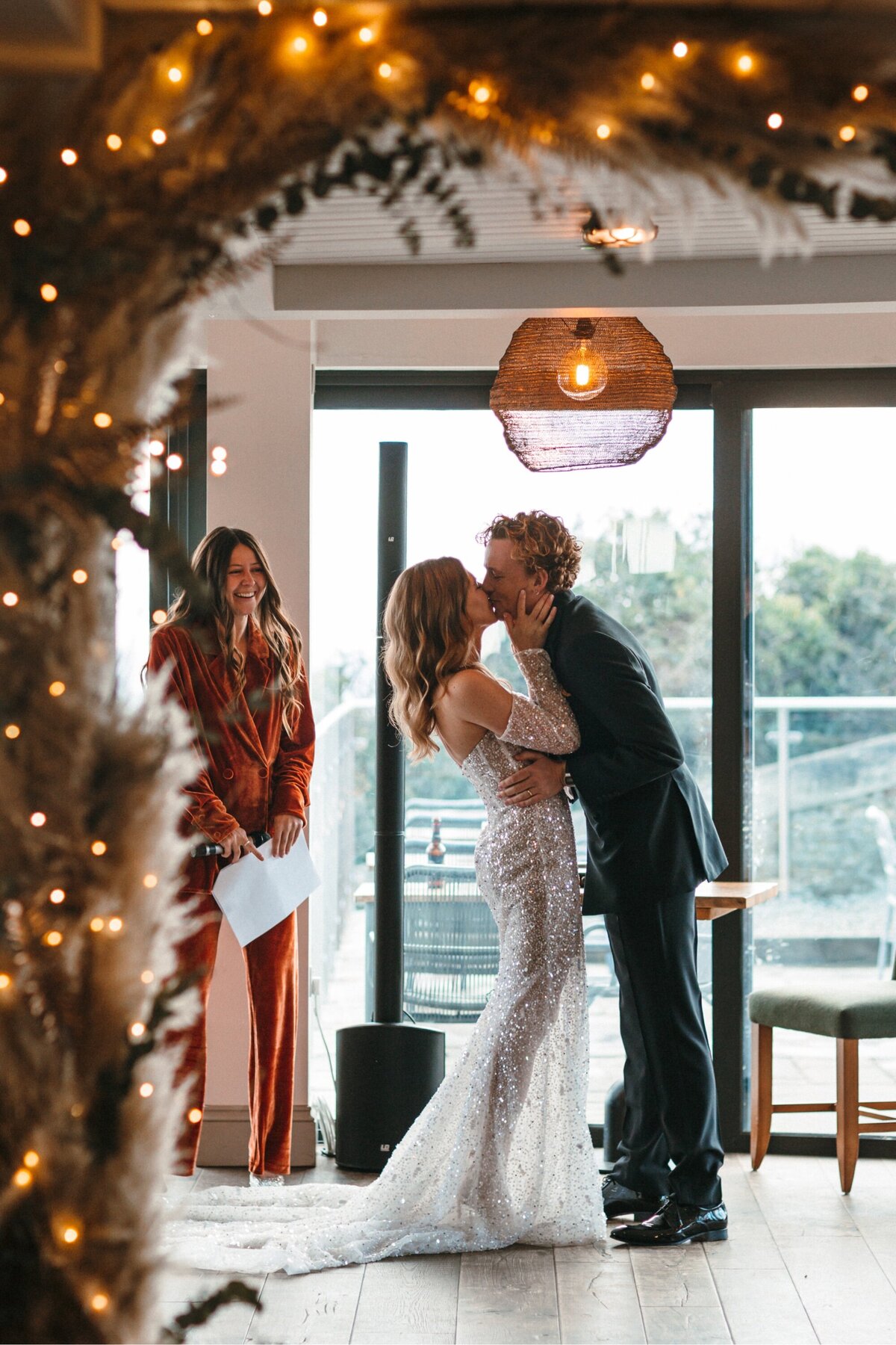 First kiss at wedding at Gara rock in Devon 