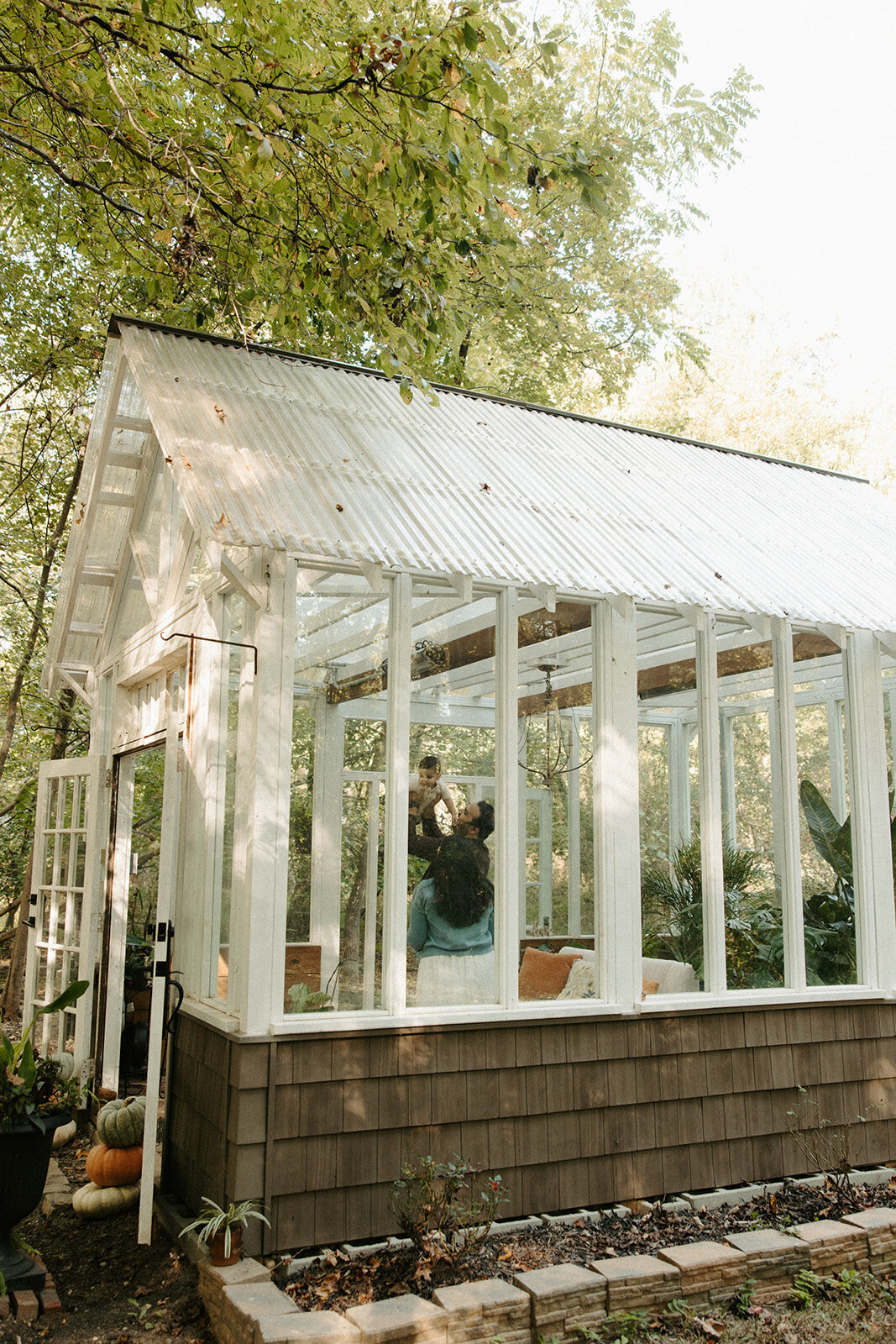 family playing with son at midlothian greenhouse during RVA family photographer's photoshoot
