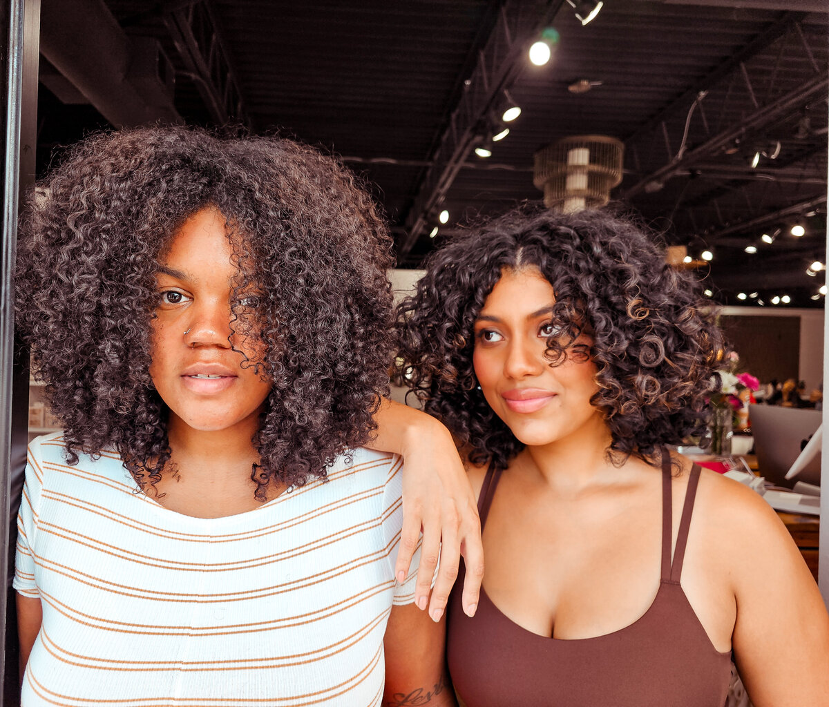 Two different big round curly hairstyles courtesy of Moxie by KC