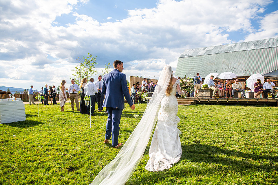Strawberry-Creek-Ranch-Wedding-Ashley-McKenzie-Photography-Romantic-Mountain-Affair-Navy-Blush-Colorado-bride-and-groom-entering-reception