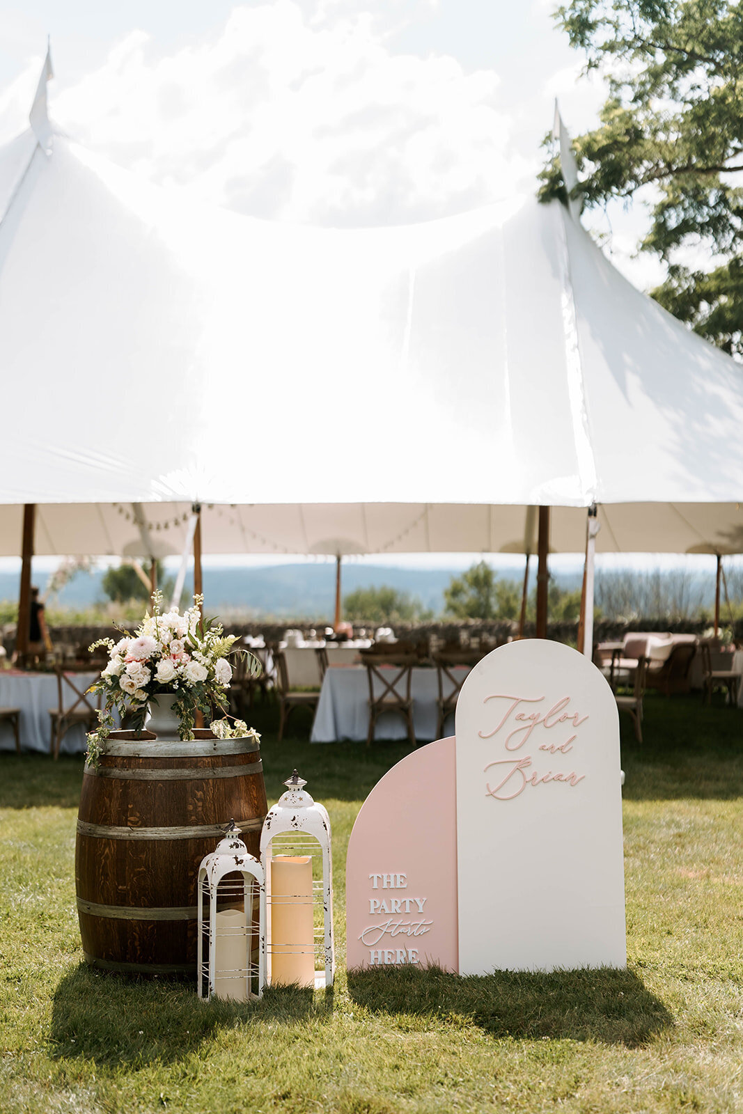 tented wedding entrance with blush and white welcome sign in upstate new york