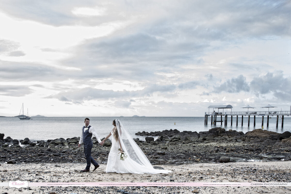 Capturing love's journey by the shore! Experience the magic of a couple's blissful stroll along the Coral Sea beach through enchanting wedding photography. Cherish timeless moments by the ocean waves with our picturesque captures of love and togetherness.