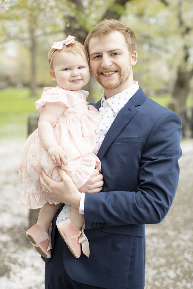 portrait of dad holding daughter during spring family portraits