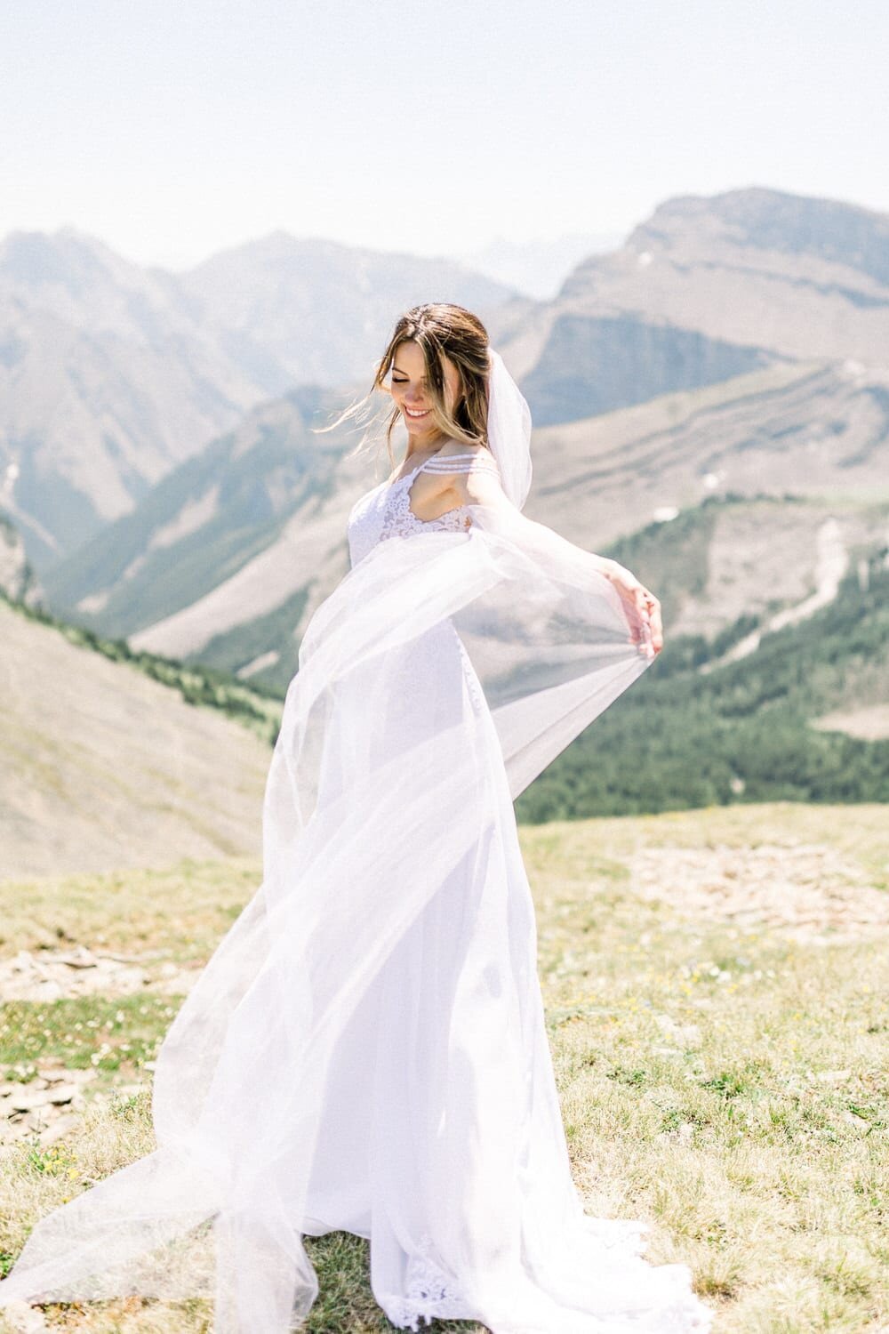 Bride-playing-with-her-dress-during-their-mountain-wedding-helicopter-day-3