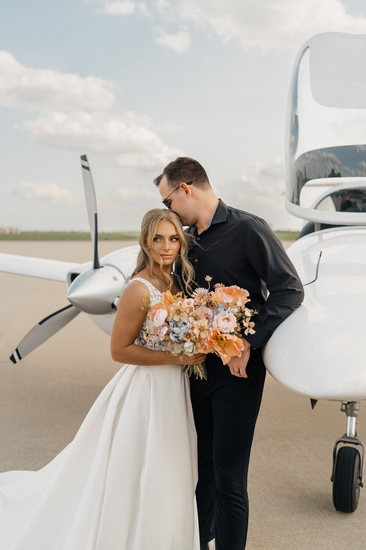 Bride and groom holding hands at sunset, captured by a Tulsa wedding photographer.
