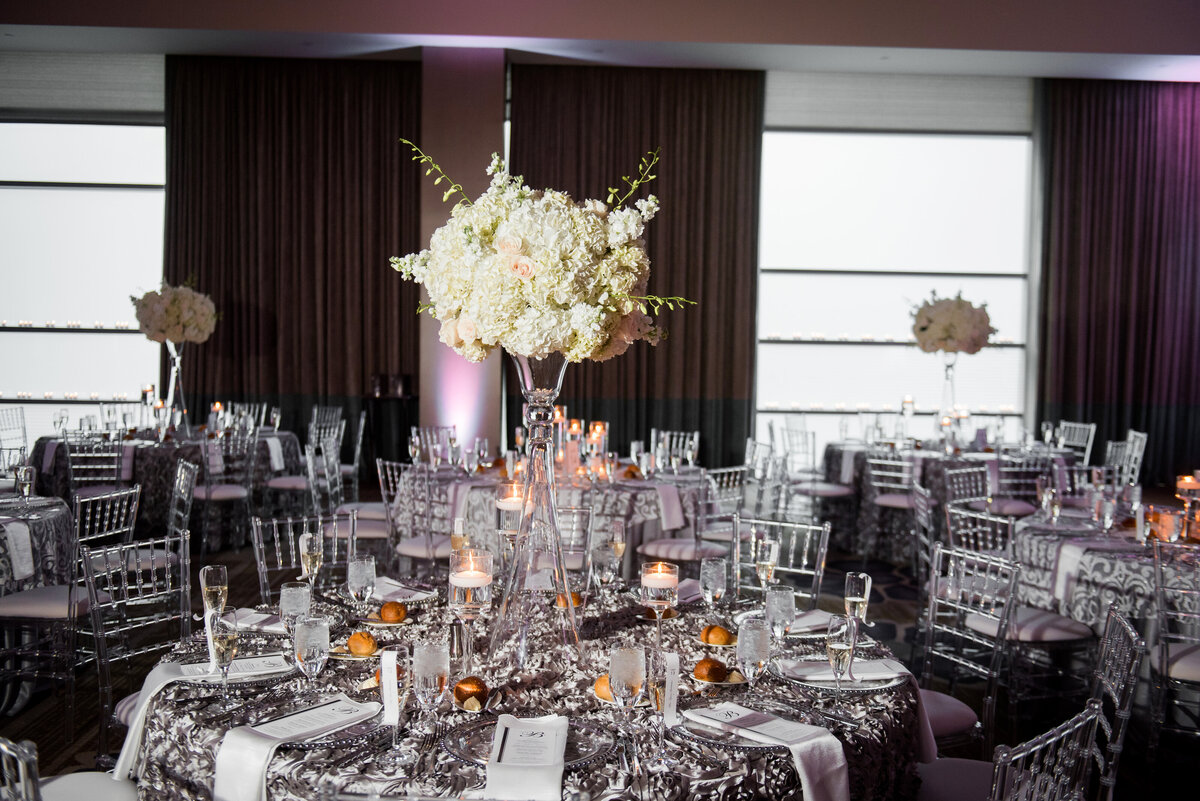 reception with purple flowers and silver linens