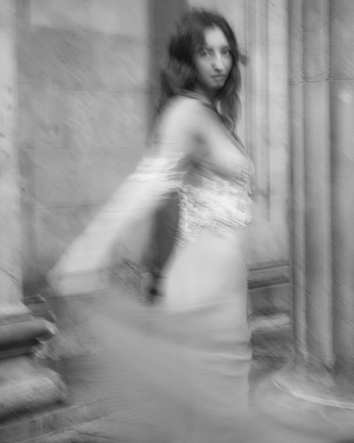 Bride in motion blur spins in a bespoke wedding dress