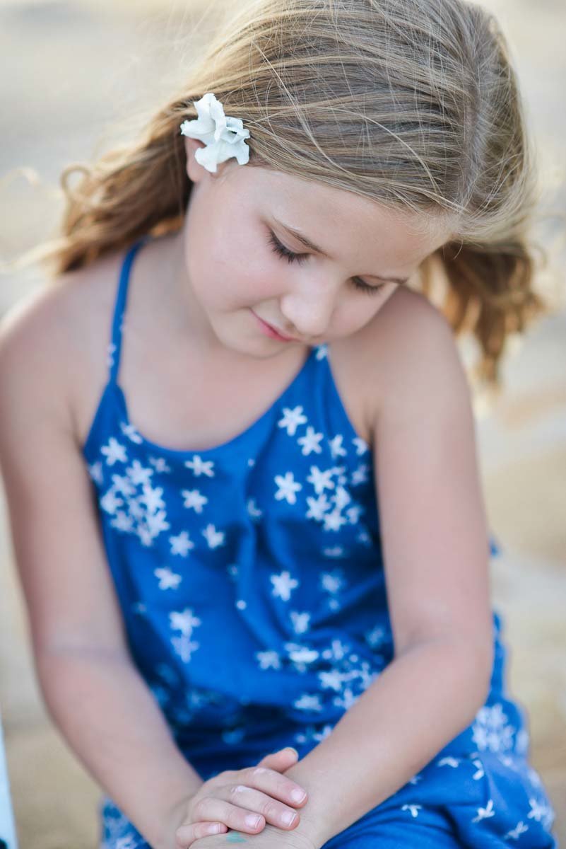 girl in blue dress with flower in hair