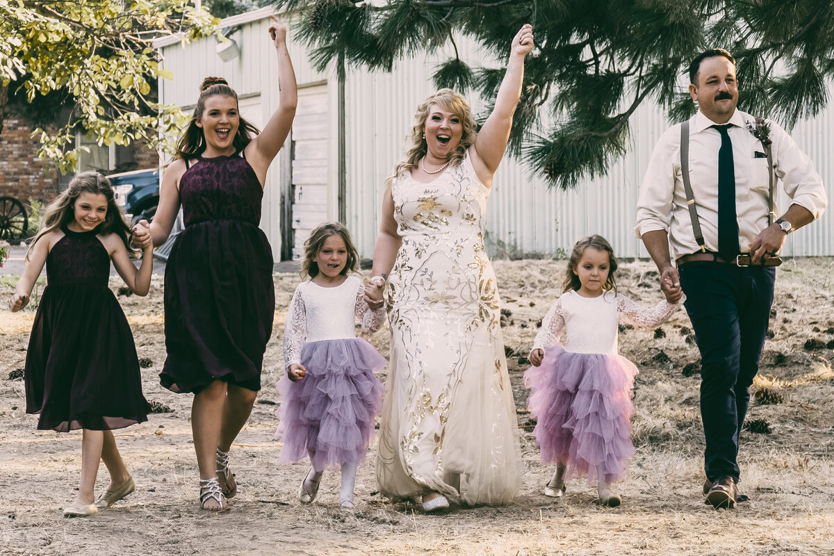 A candid shot of bride, groom and their kids during a wedding in Mendocino, California