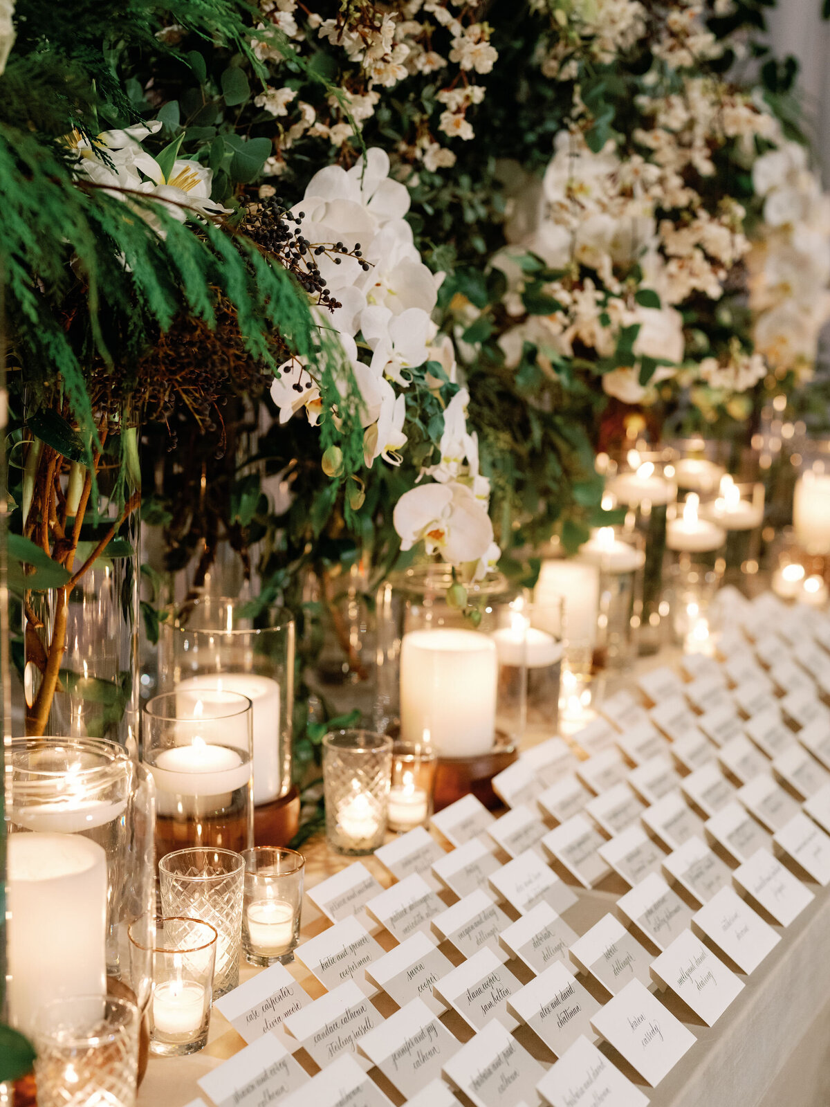 A close up of table placements on a table with candles. 