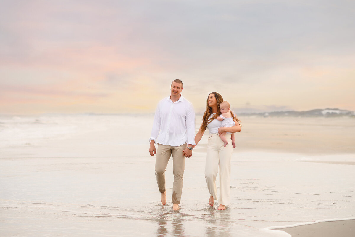 Family walks along the beach together during Family Photos on Isle of Palms. 