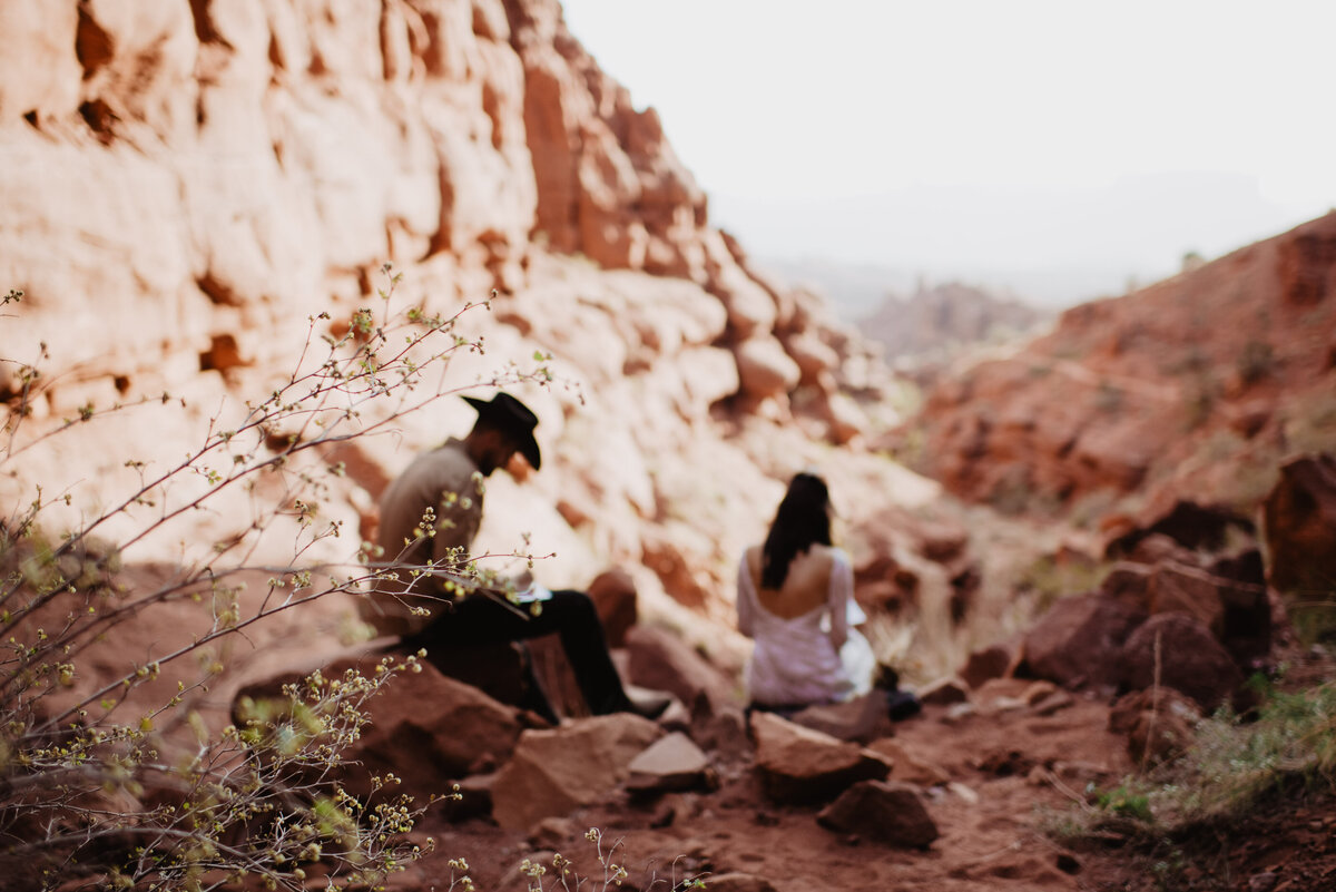 Utah Elopement Photographer captures couple sitting together during portraits