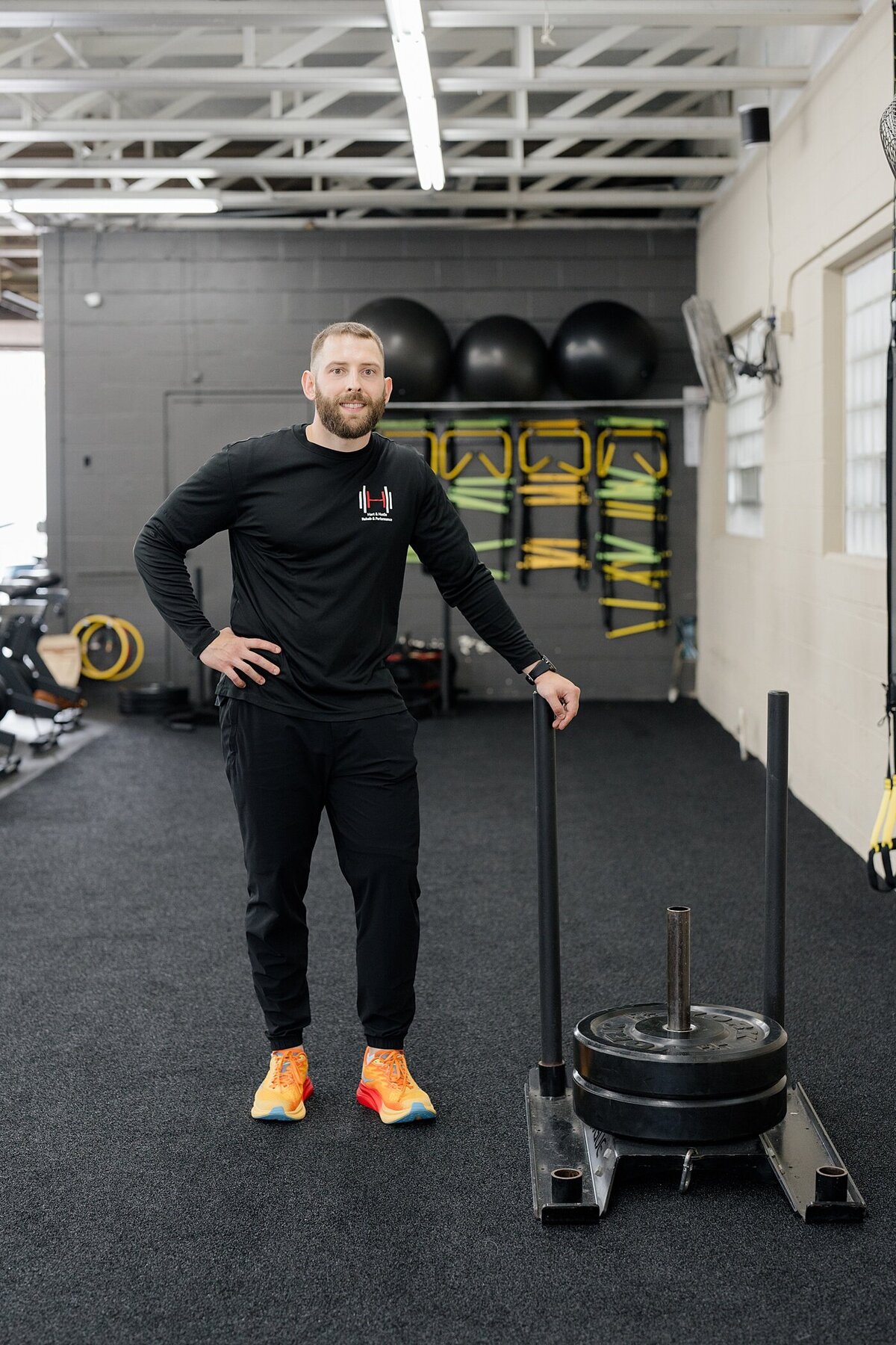 Columbus photographer captures portrait of small business owner personal trainer standing with some equipment a and a hand on his hip