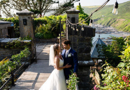 A bride and groom pose for a picture on their wedding day