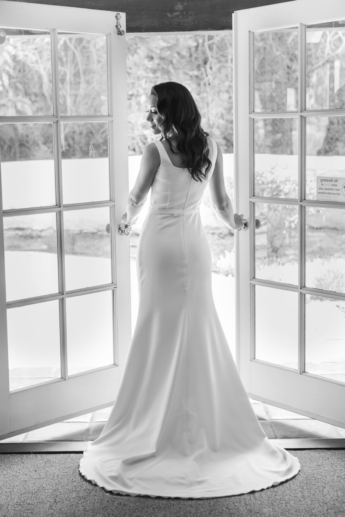 bride walking out windowed door