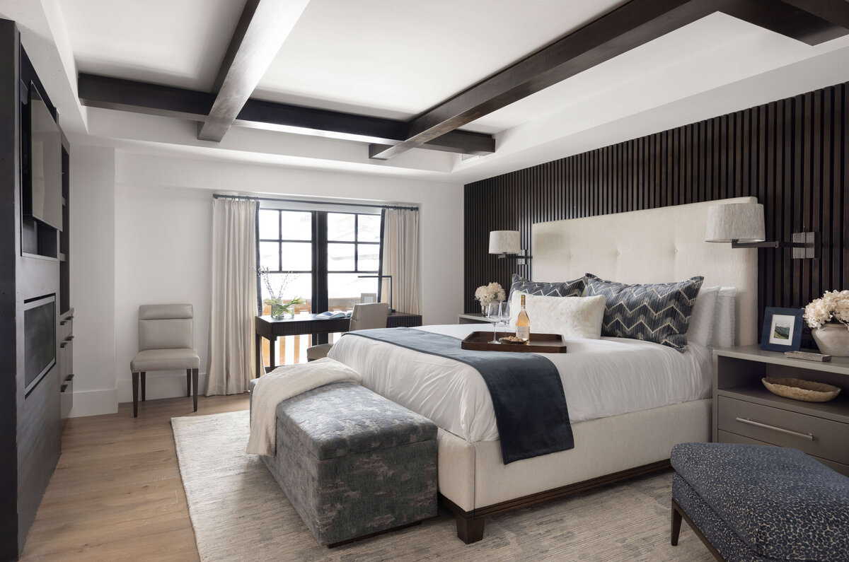 bedroom with white bed and dark exposed beams