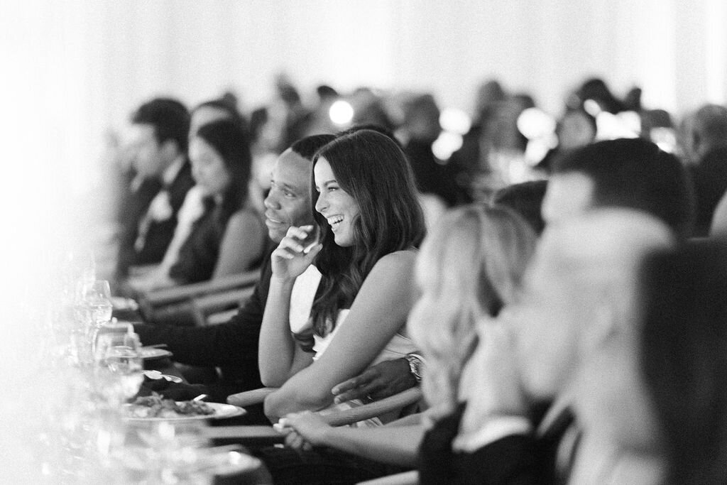 Black and white photo of the bride and groom laughing.